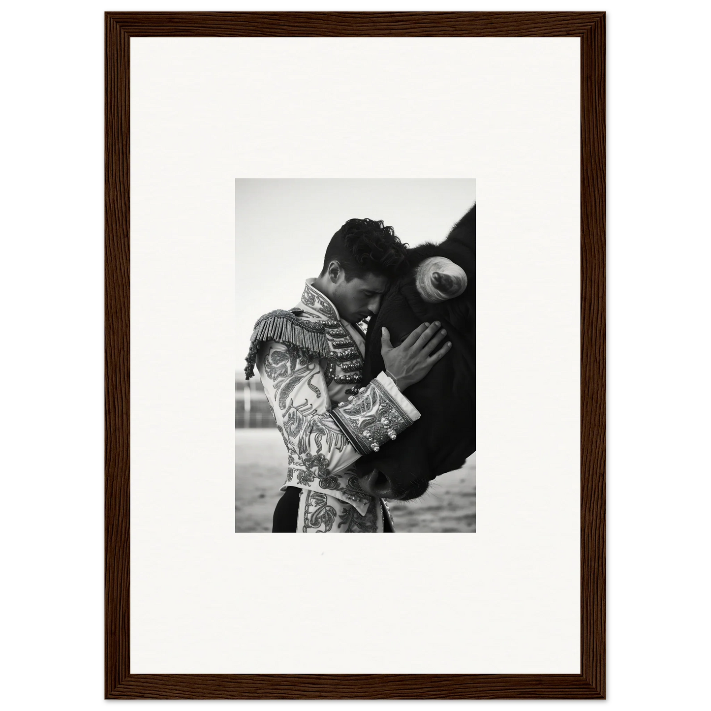 Matador embracing a bull in a stunning black and white photo from Triumphant Shadows Embrace