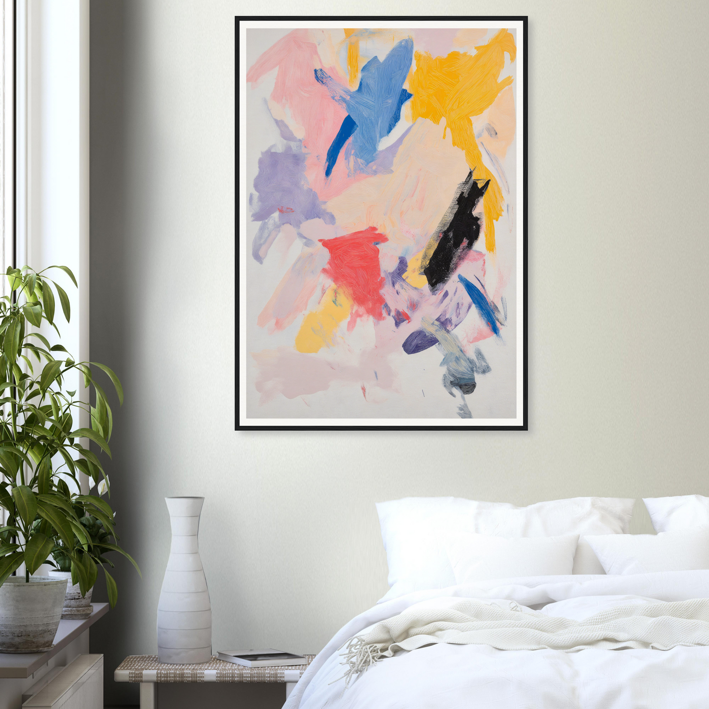 Framed wall art in bold colors hangs above a white bed, enhancing the room decor with style.