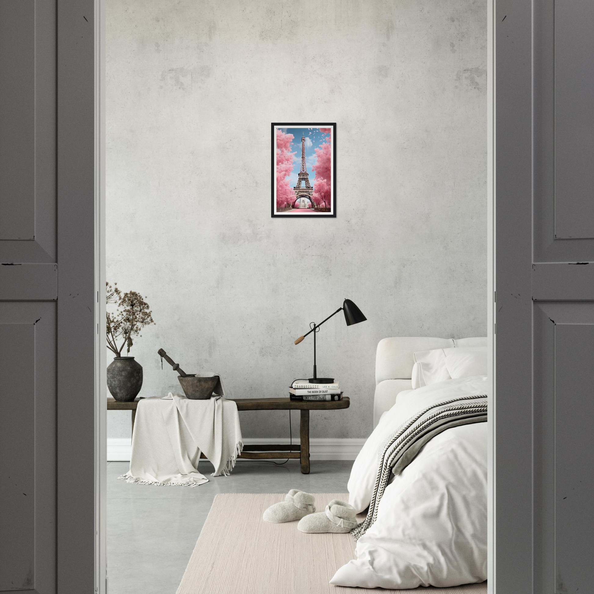 A bedroom with a bed, a table and a painting on the wall