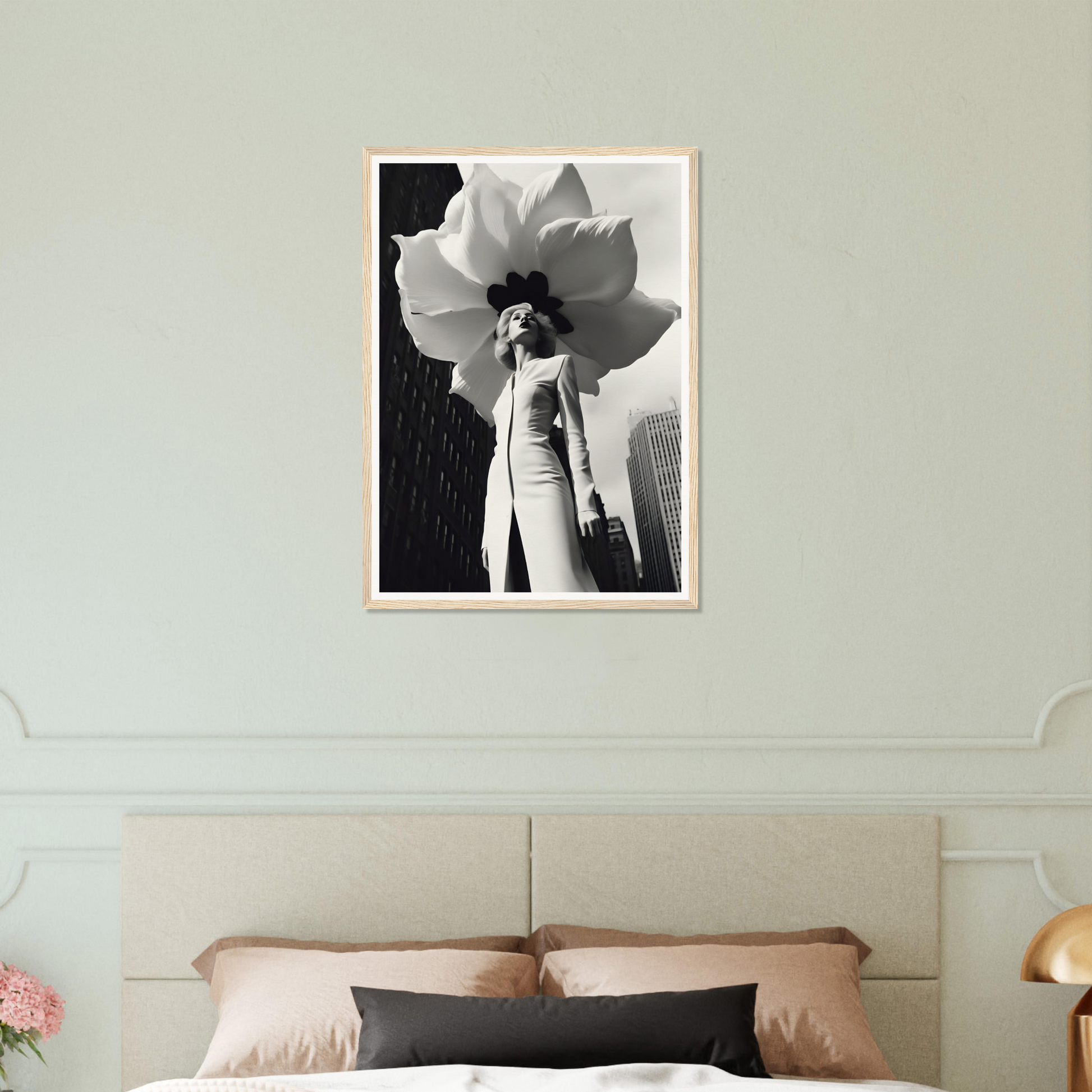 A black and white photo of a flower on a wall