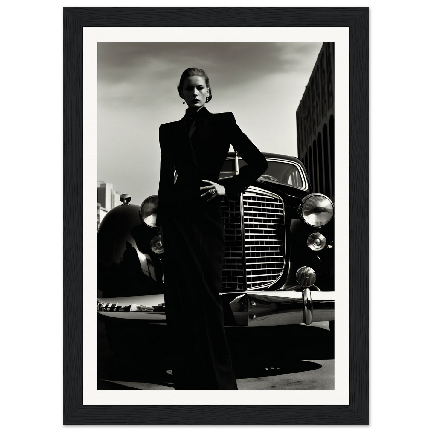 A black and white photo of a man in a suit leaning on a car