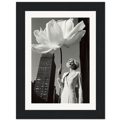 A black and white photo of a woman holding a large white flower