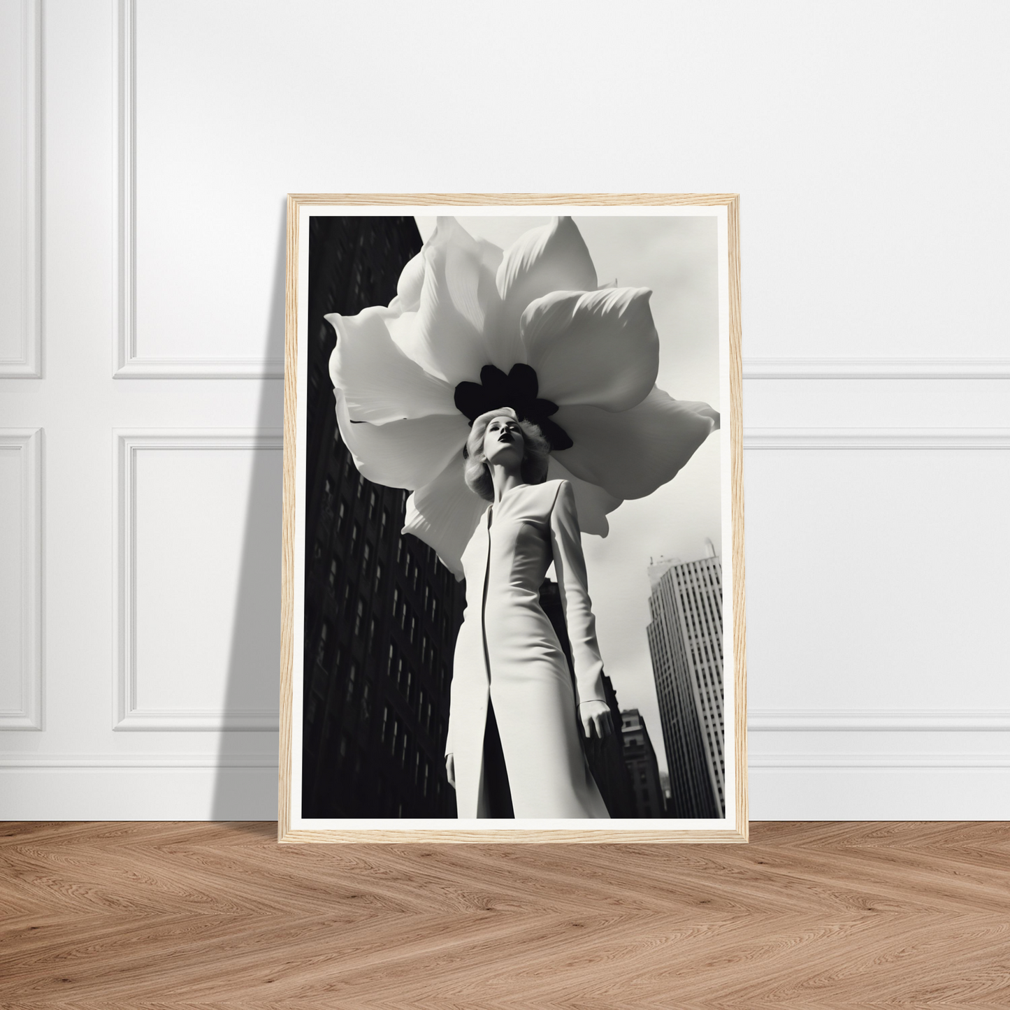 A black and white photo of a woman holding a large flower