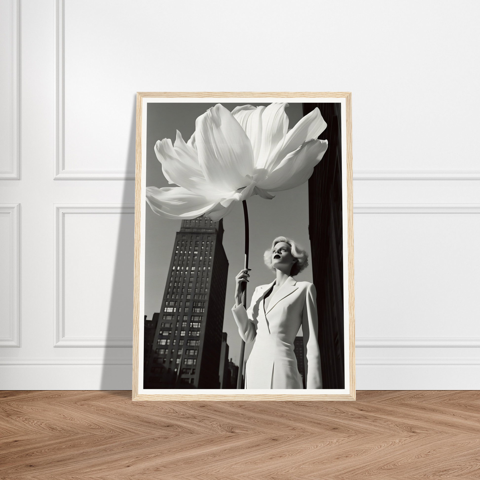 A black and white photograph of a woman holding a flower