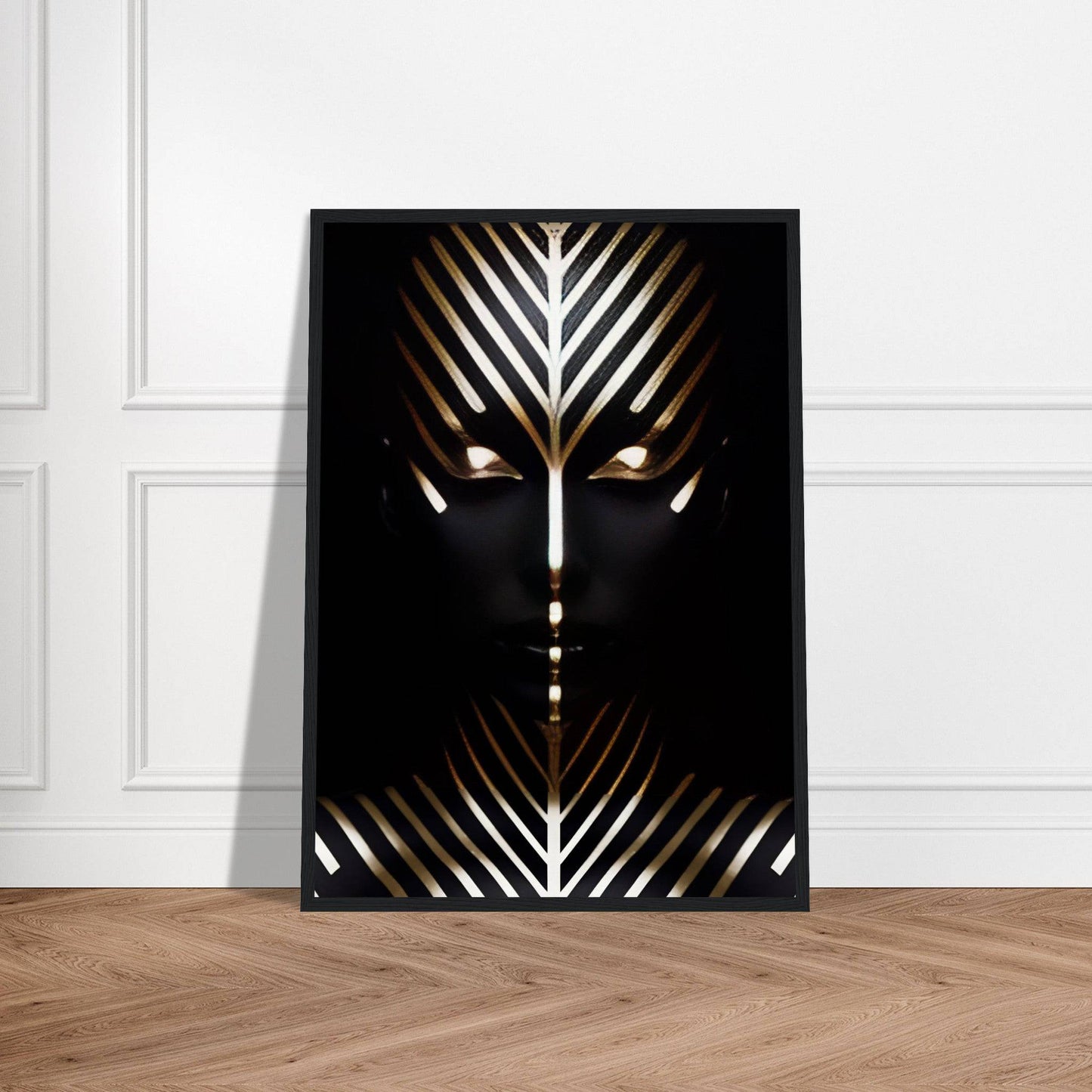 Framed abstract art piece featuring a stylized face with geometric gold and white patterns on a black background.