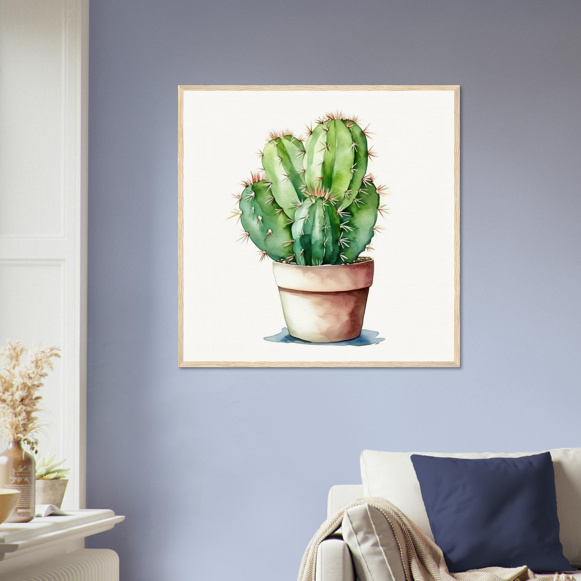 A cactus plant in a pot on a blue wall