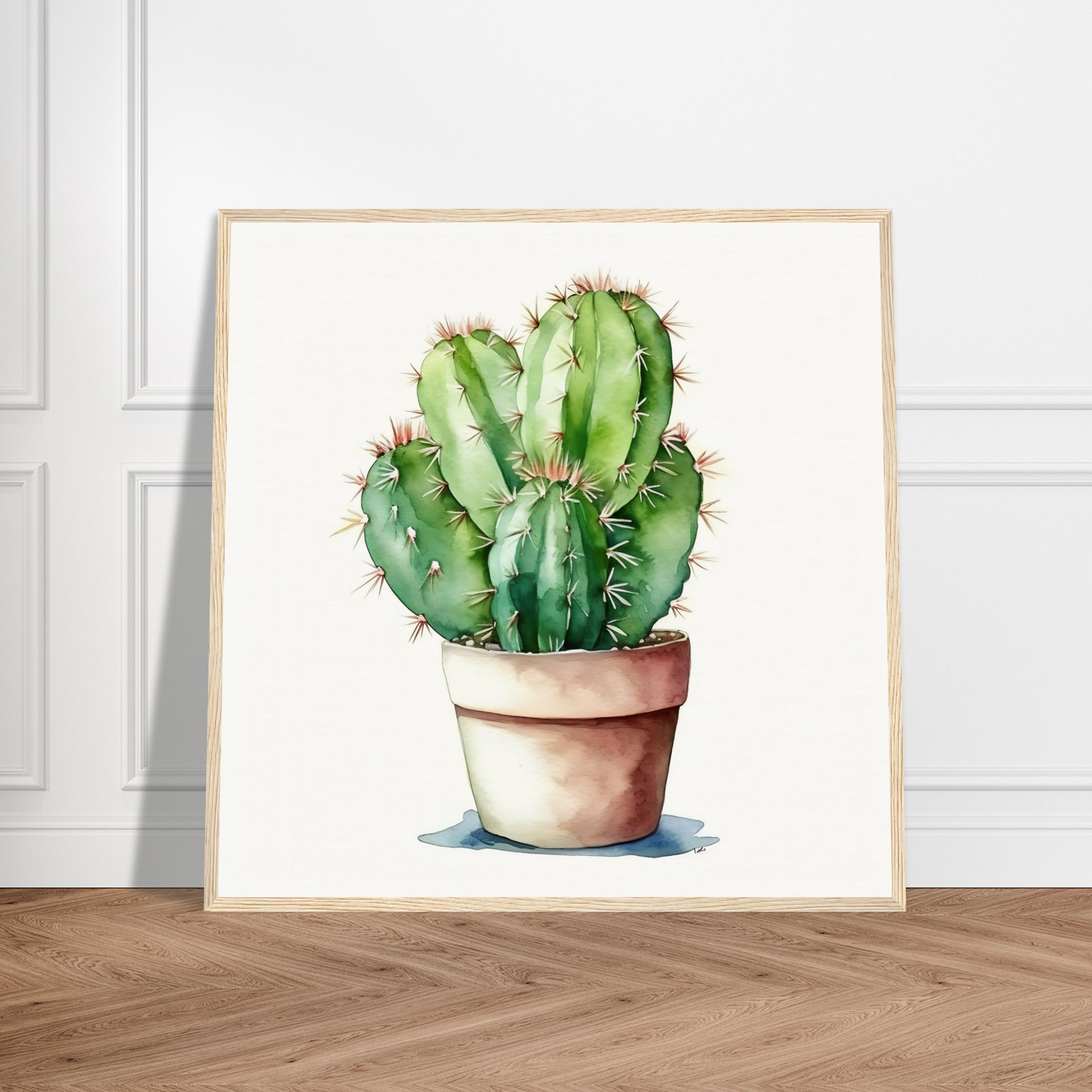 A cactus plant in a pot on a wooden floor