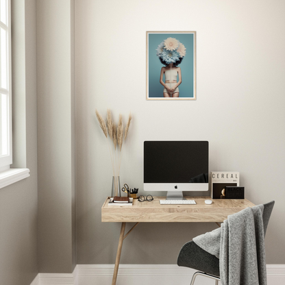 Minimalist home office workspace with a wooden desk, computer, and decorative wall art.