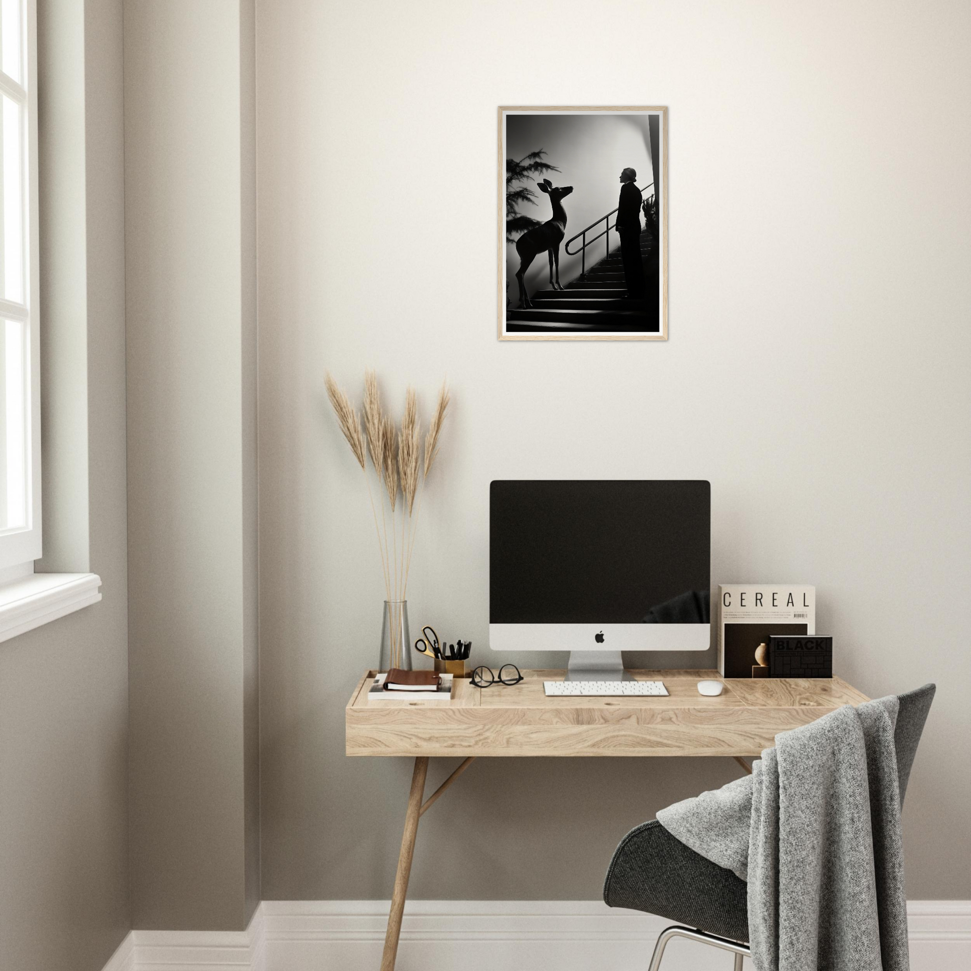 Minimalist wooden desk with a computer monitor and office accessories.