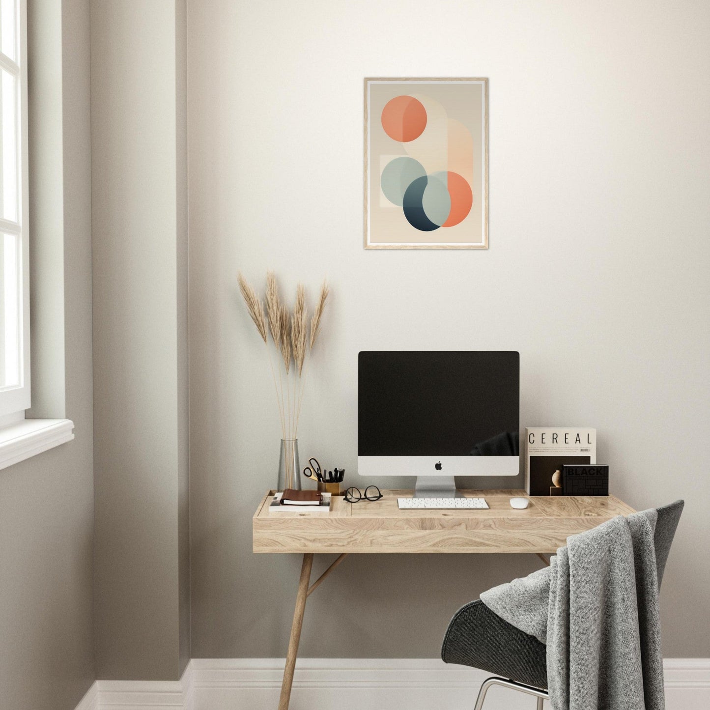 Wooden desk with a computer monitor, office supplies, and decorative elements.