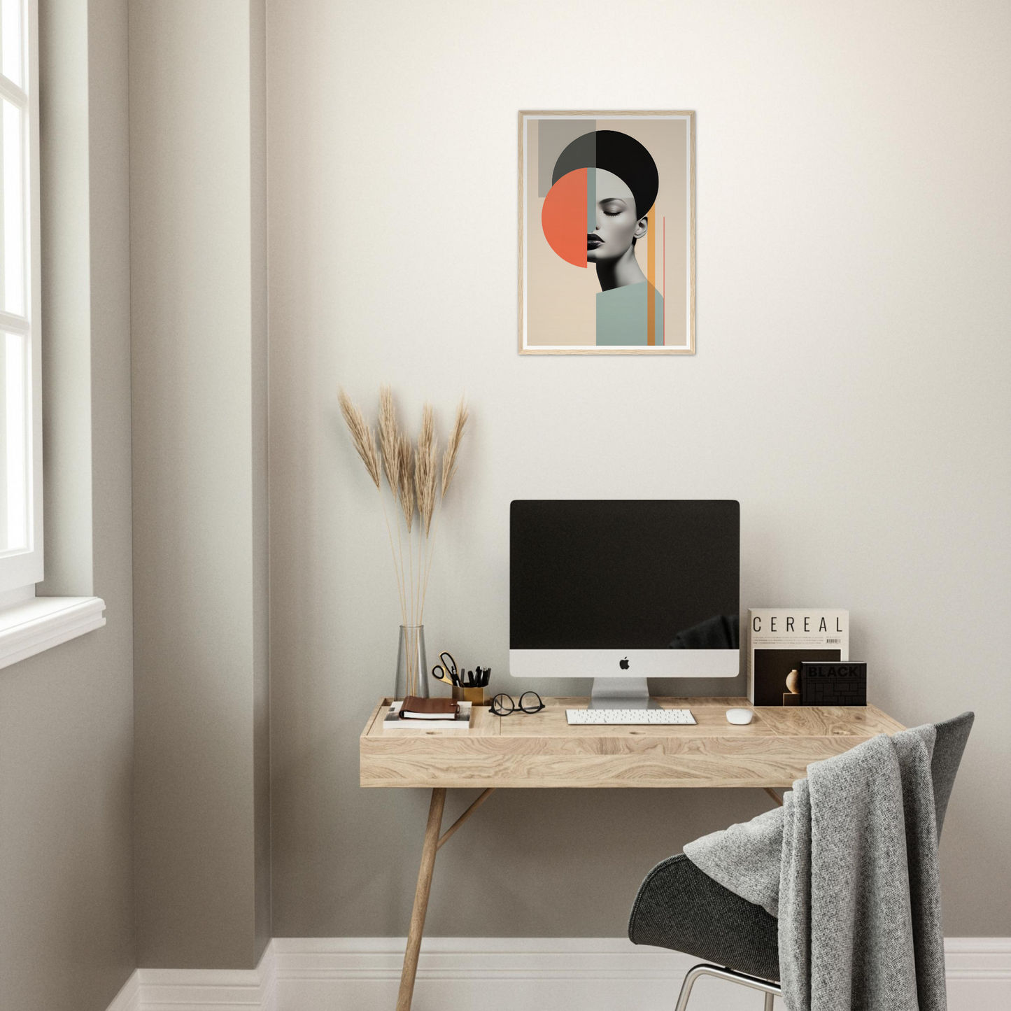 Minimalist home office workspace with a wooden desk, computer, and abstract wall art.