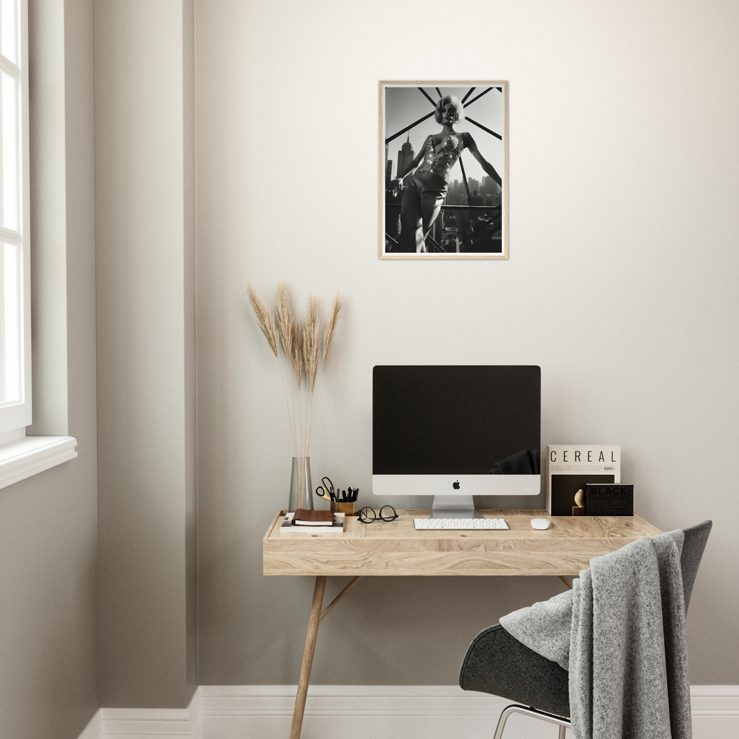 Minimalist wooden desk with a computer monitor and decorative elements.