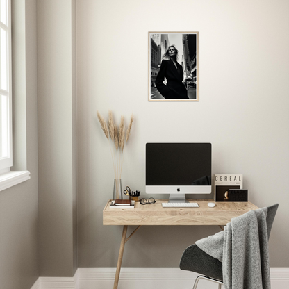 Minimalist wooden desk with a computer monitor and decorative accessories.