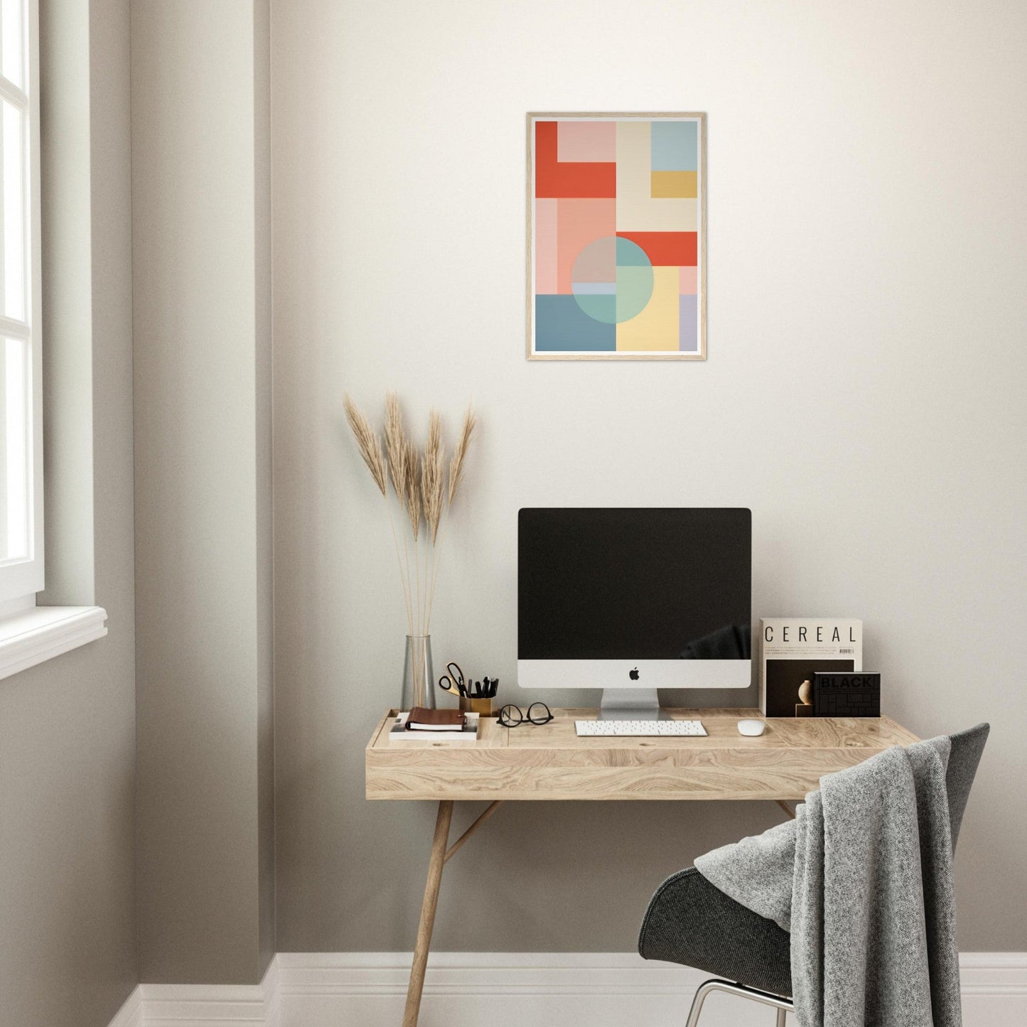 Minimalist wooden desk with a computer monitor and office accessories.