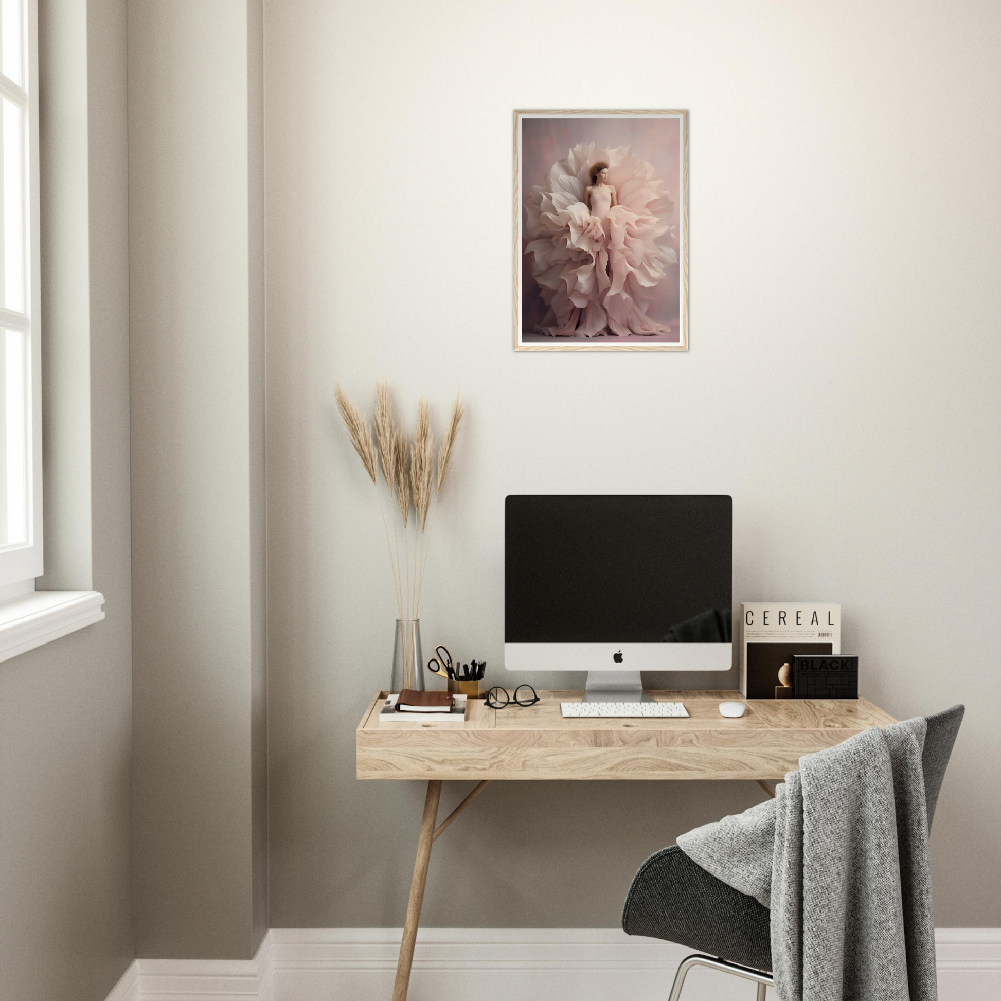 Minimalist wooden desk with a computer monitor and decorative accessories.