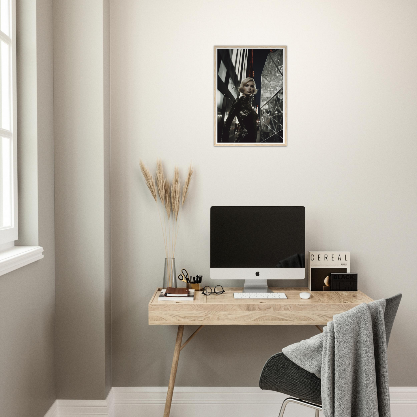 Minimalist wooden desk with a computer monitor and decorative accessories.