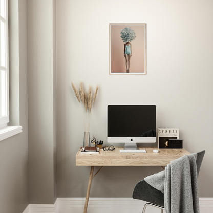 Minimalist home office workspace with a wooden desk, computer, and decorative elements.