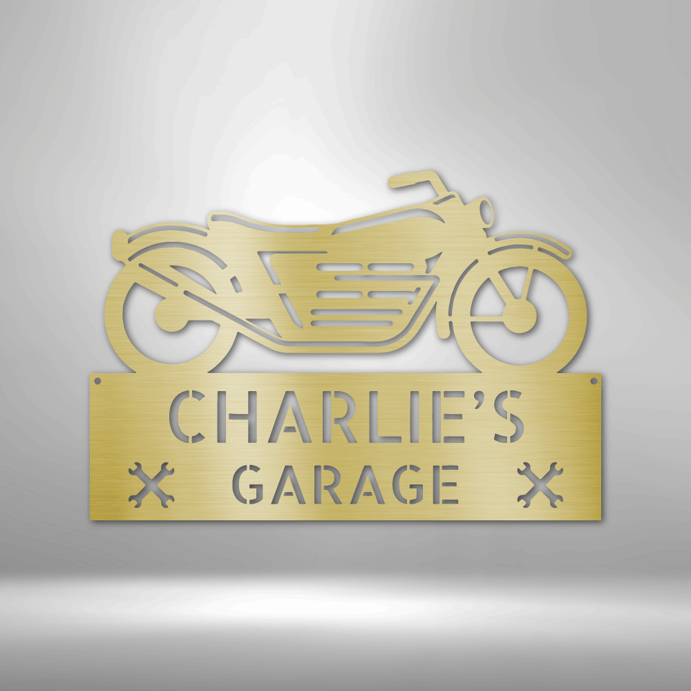 Gold-colored metal sign featuring a motorcycle silhouette and the text ’CHARLIE’S GARAGE’.