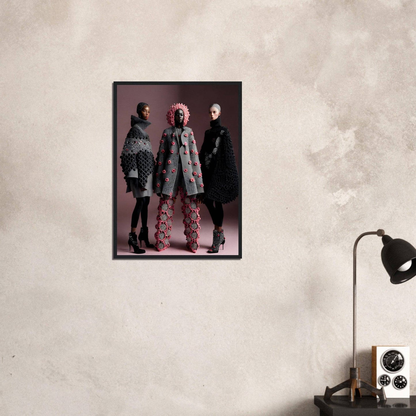 Framed photograph of three models wearing stylish winter coats on a pink background.