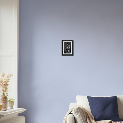 Framed black and white artwork hanging on a pale blue wall.