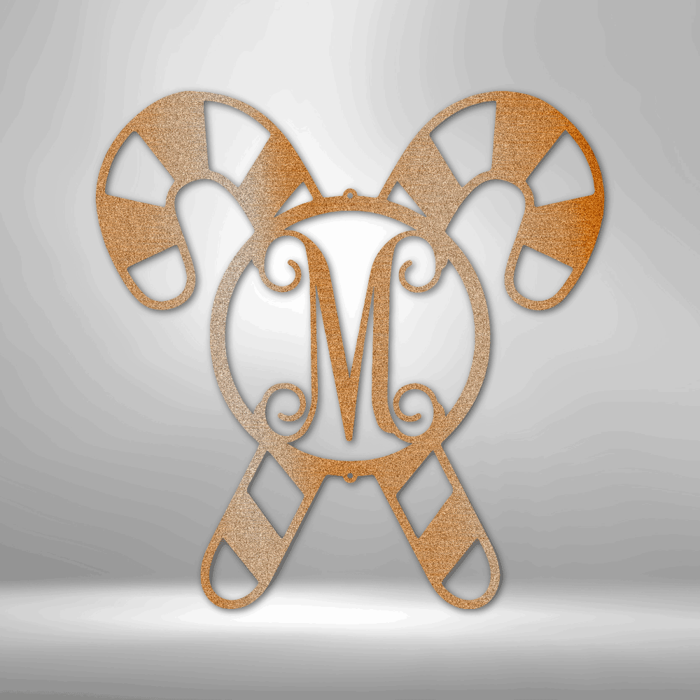 Decorative monogram featuring the letter ’M’ surrounded by stylized candy cane shapes.