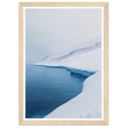 Framed wall art of a snowy landscape with calm waters and snow-covered slopes is stunning room decor.