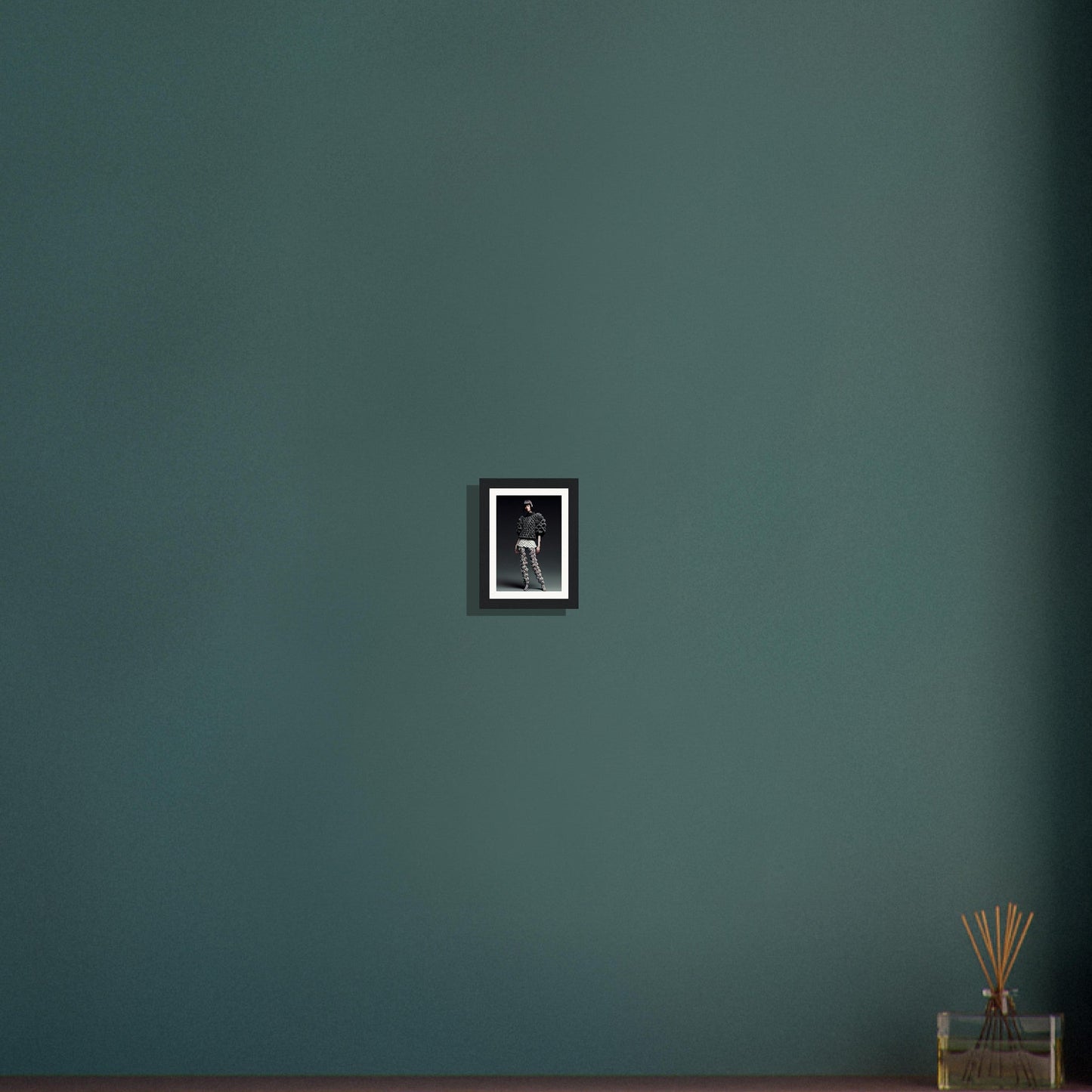 A dark green wall with a black frame and a small black cat