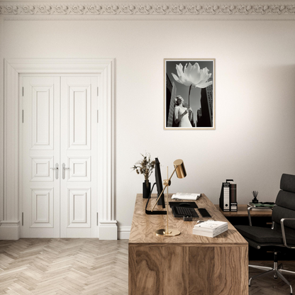 A desk with a chair and a framed photo on the wall