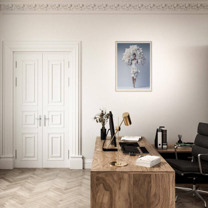 A desk with a chair and a framed picture on the wall