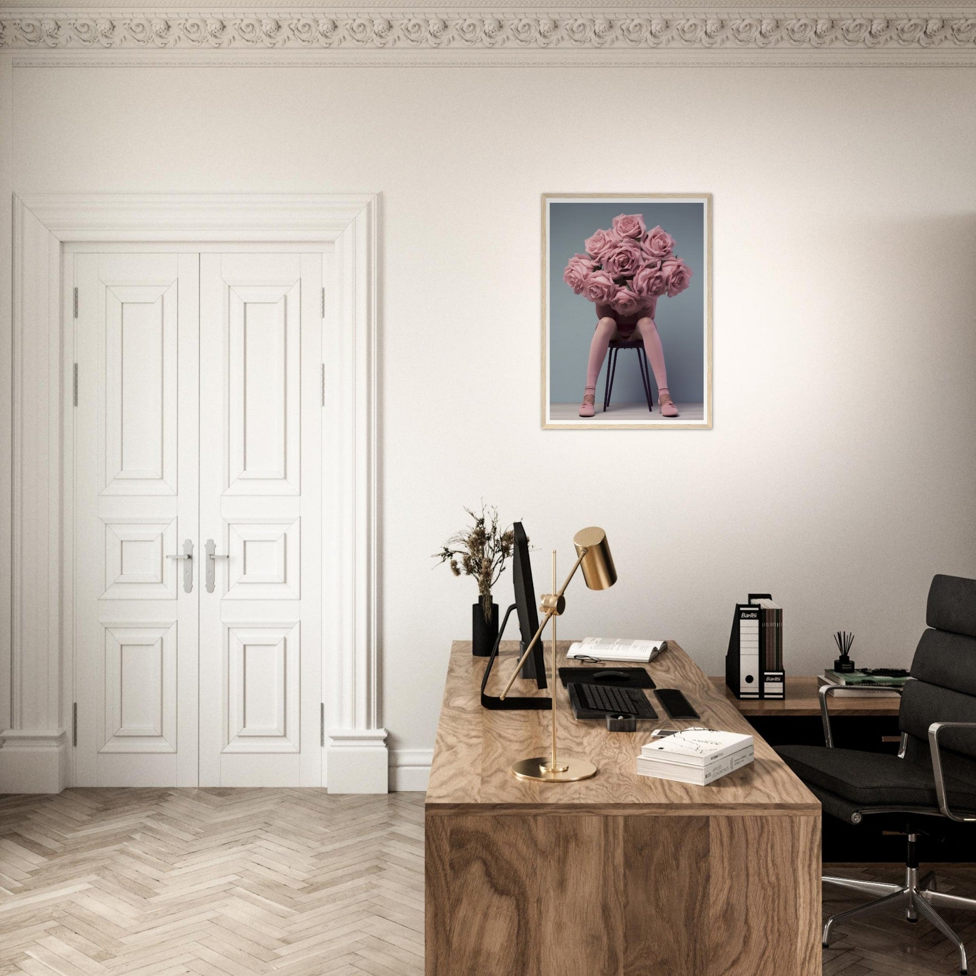 A desk with a chair and a painting on the wall