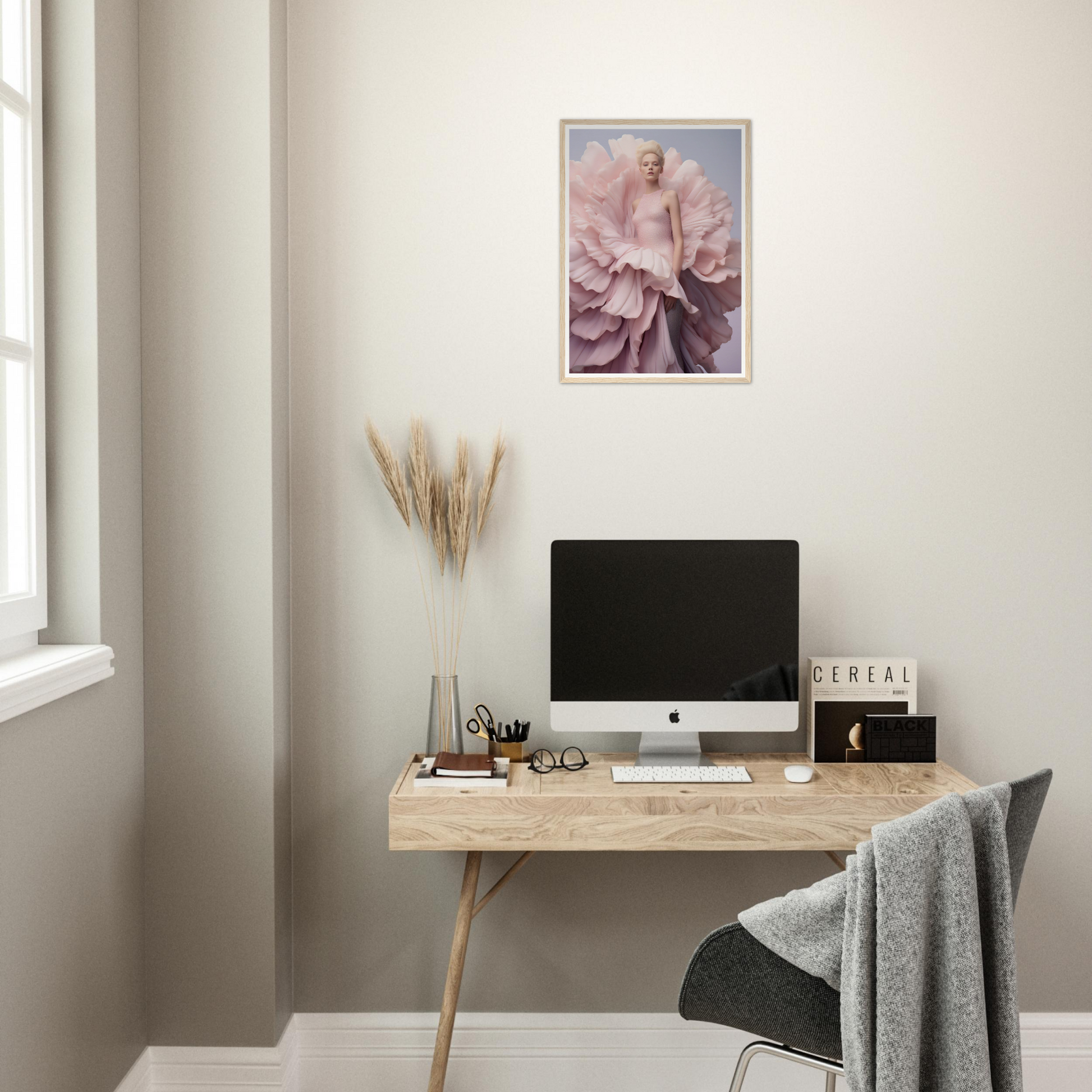 A desk with a computer and a flower on it