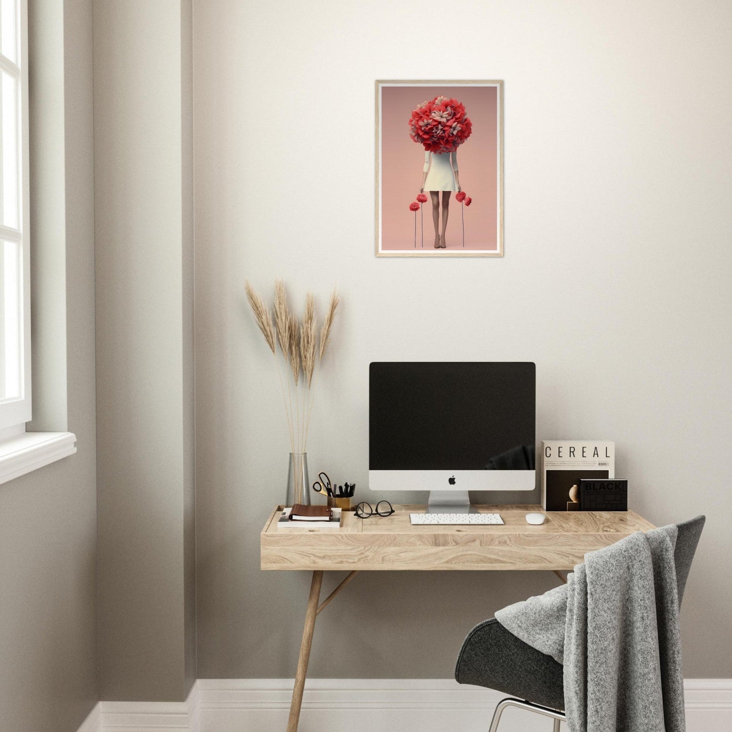 A desk with a computer and a flower on it