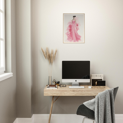 A desk with a computer and a pink painting on the wall