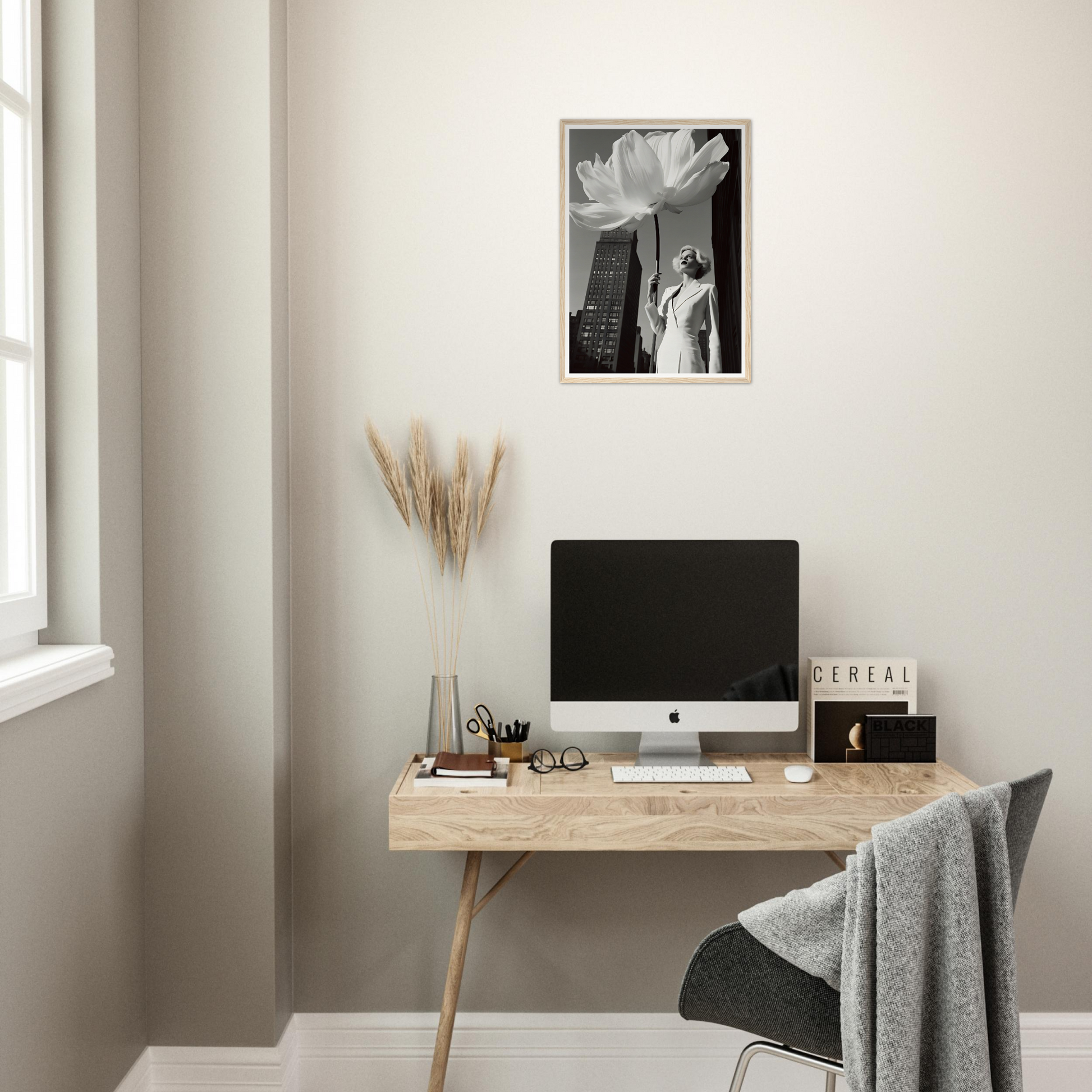 A desk with a computer and a plant on it