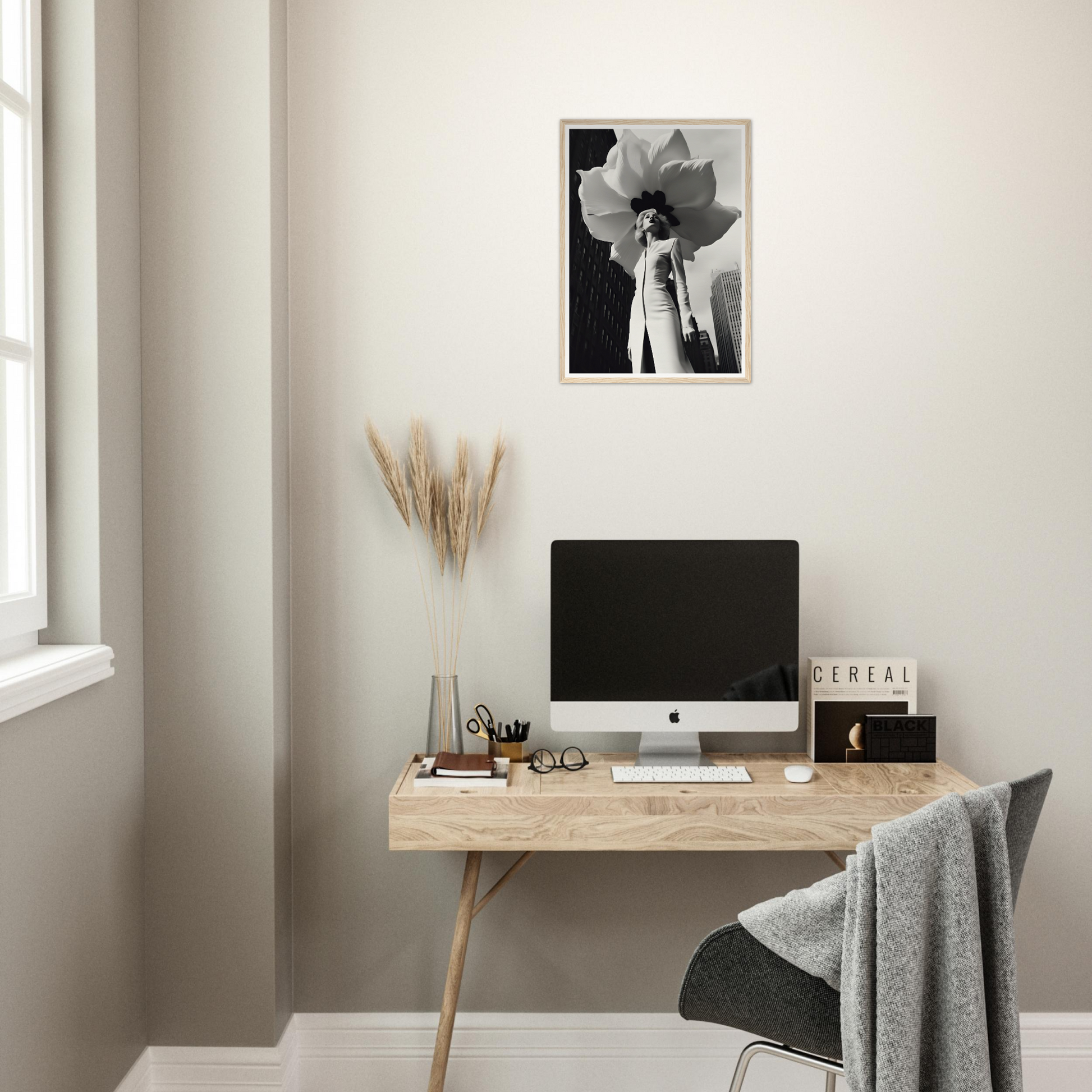 A desk with a computer and a plant on it