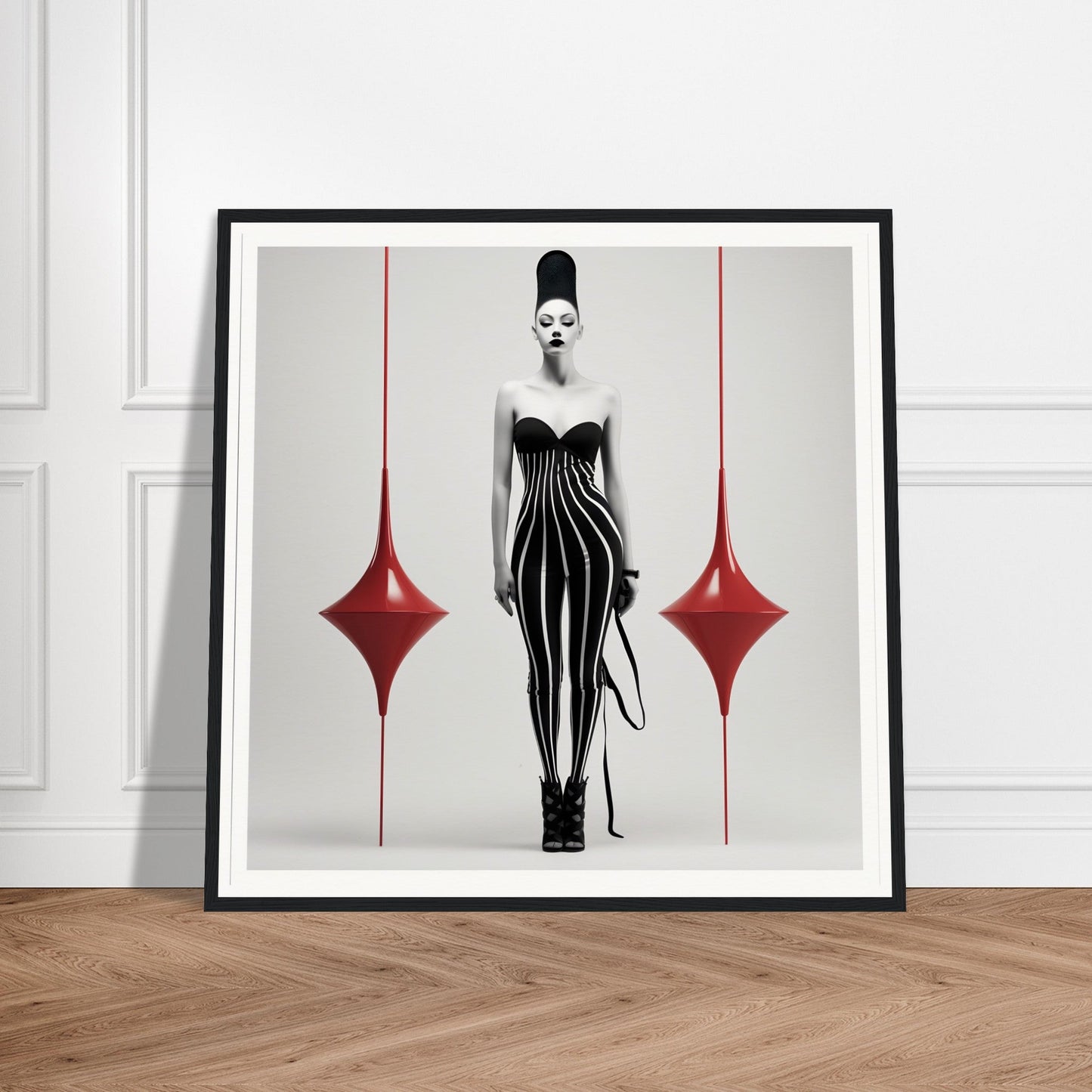 Framed artwork depicting a stylized female figure in a black striped dress flanked by red diamond shapes.