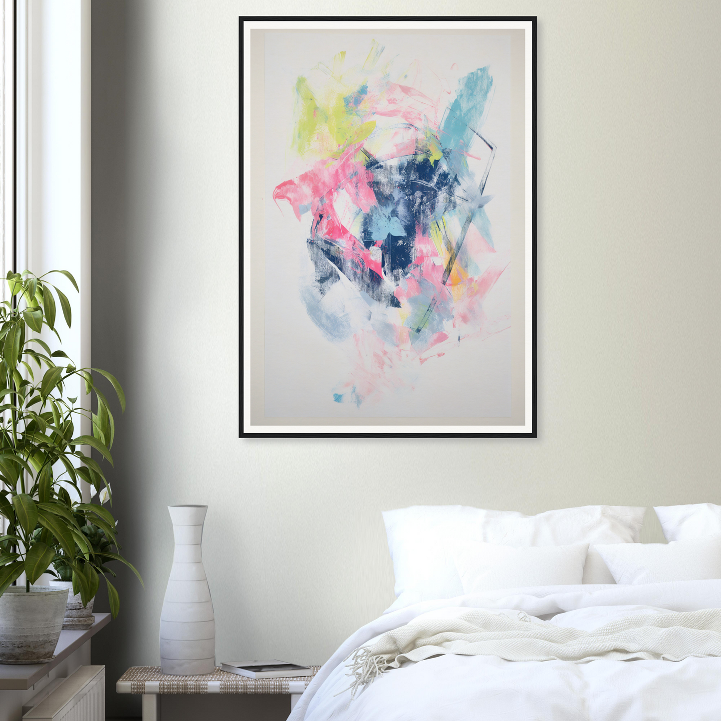 Framed wall art with pink, blue, and yellow hues adorns the room decor above a bed.