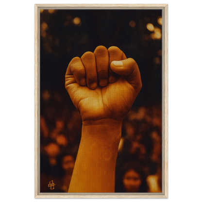 A raised fist illuminated in warm light, embodying Earthy Defiance Resonate framed canvas print