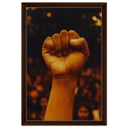 Raised fist symbolizing Earthy Defiance on a blurred background for Framed Canvas Print