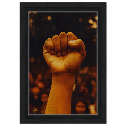 Raised fist illuminated in warm light, symbolizing Earthy Defiance, framed canvas print