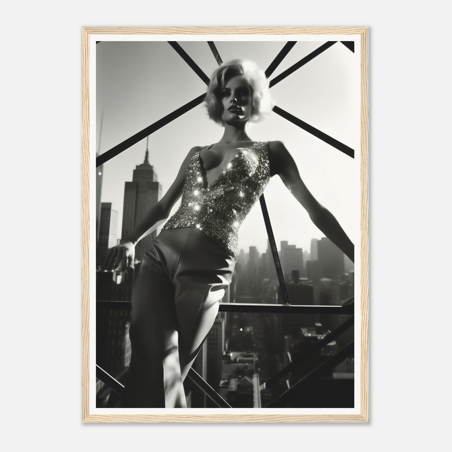 Black and white photograph of a woman in a glittering bodysuit posing against a city skyline.