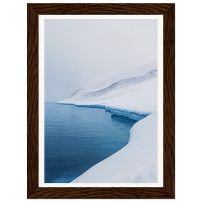 Framed wall art of a snowy landscape with calm blue water, perfect for room decor.