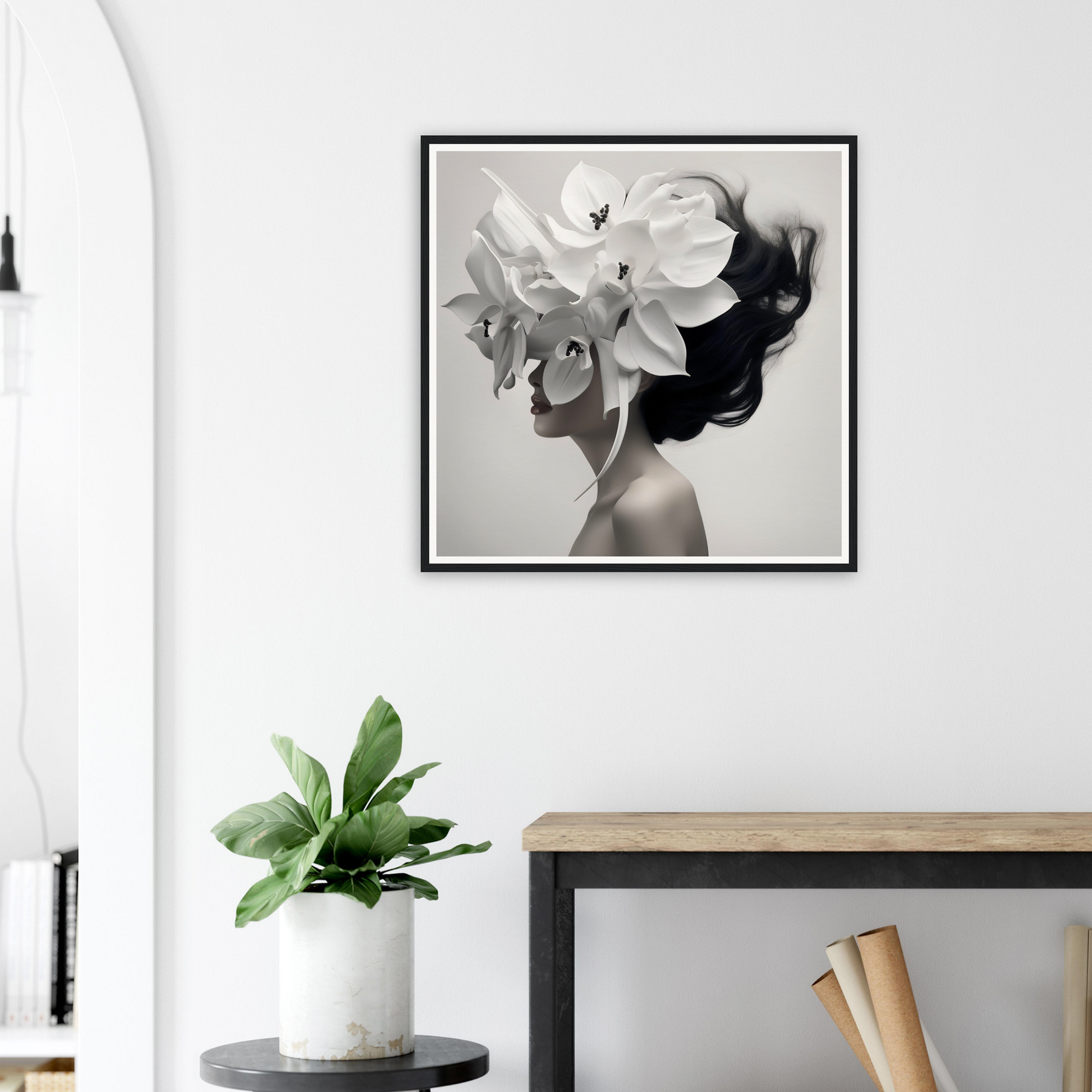 Framed black and white artwork depicting a figure with flowers blending into their silhouette.