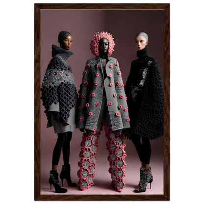 Framed photograph of three models wearing avant-garde, textured coats and pants with floral and geometric embellishments in gray, black, and pink tones.