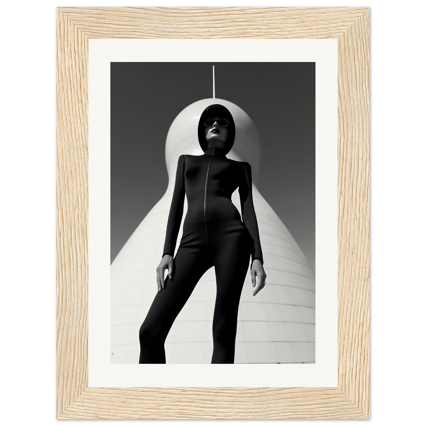 Striking black-and-white photograph of a figure in a sleek bodysuit posed dramatically beneath a curved white shape.