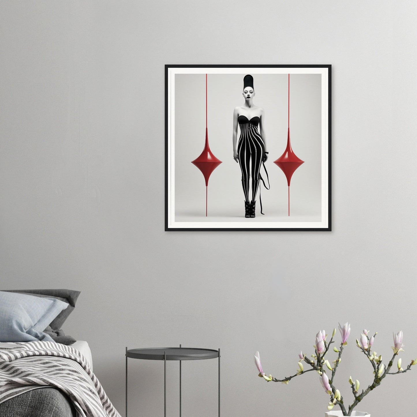 Framed artwork featuring a stylized figure in a black dress with red diamond shapes on either side.