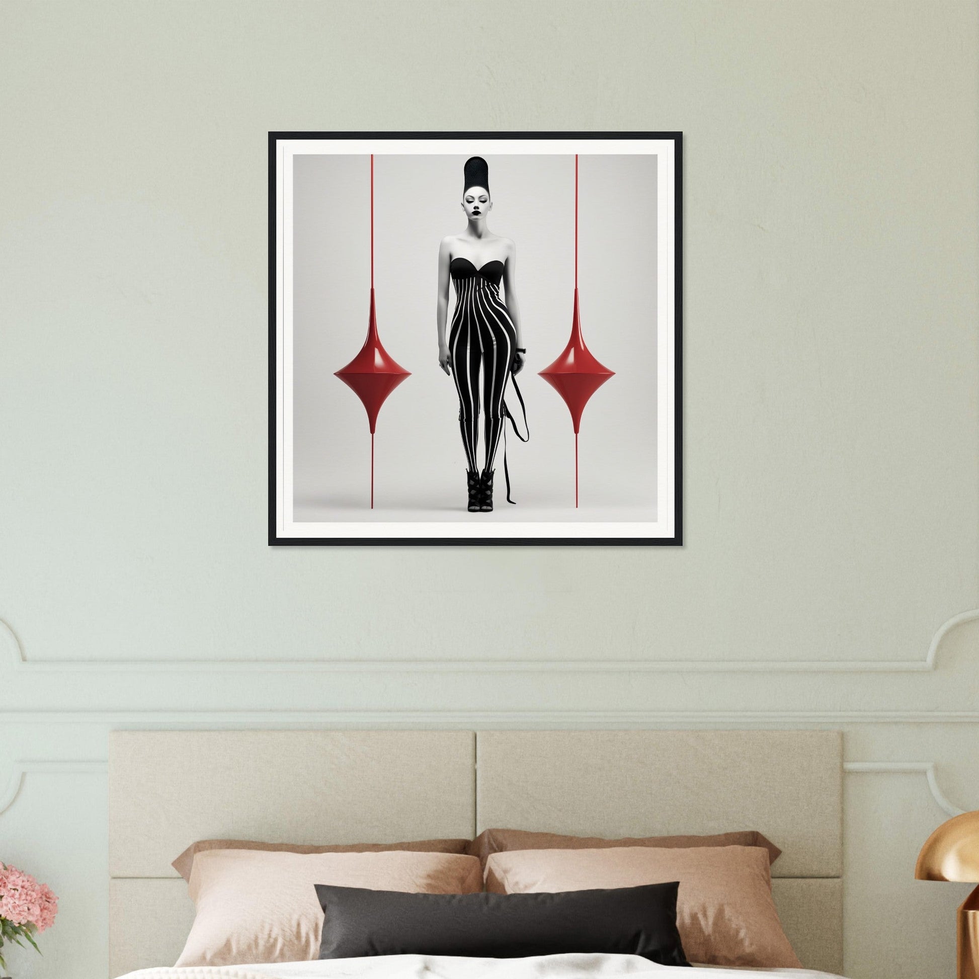 Framed black and white artwork featuring a stylized female figure in a striped dress flanked by two red diamond shapes.