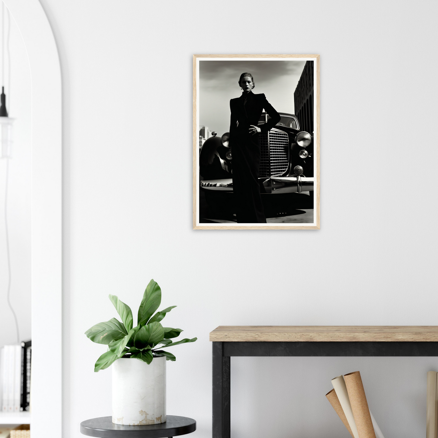 A framed photograph of a man in a suit and tie leaning on a car