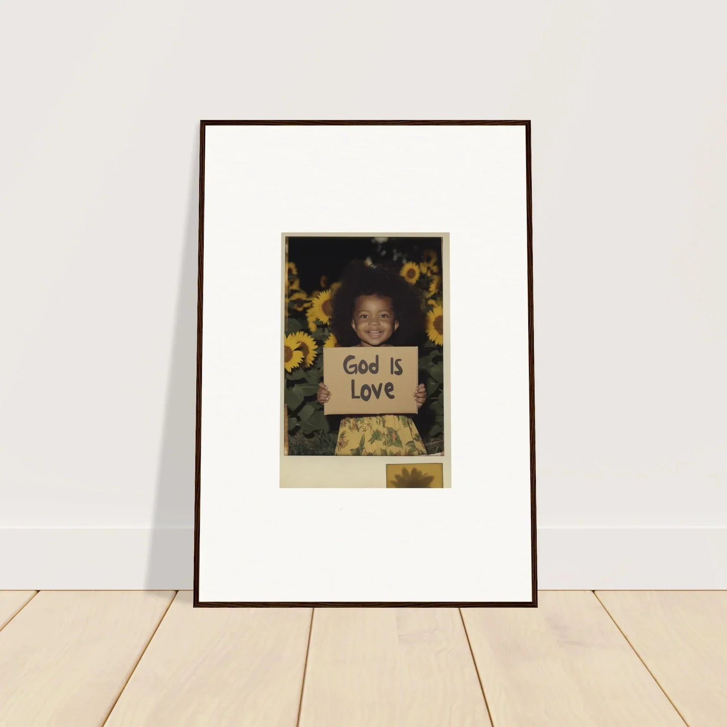 Framed photo of a child with God is Love sign surrounded by sunflowers for room decoration