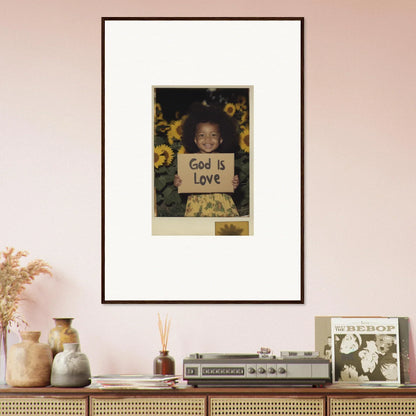 Framed wall art of a person with a God Is Love sign and sunflowers for room decoration